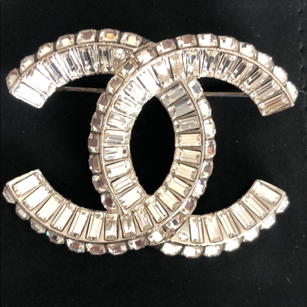 Chanel brooch  Silver tone box, dust bag and tag.